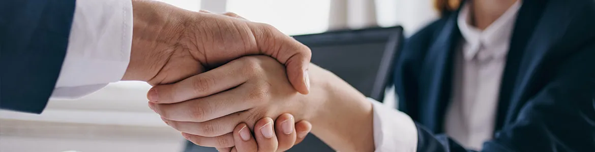 close up hand shake of two officials