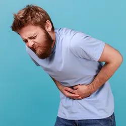 man holding his stomach in pain