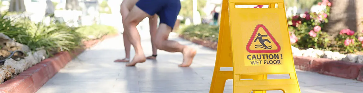 wet floor sign with a man falling outdoors