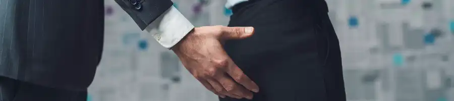 a man touching a person butt