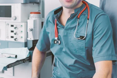 A surgeon and a nurse in a surgery room