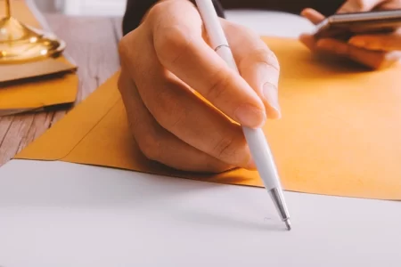 A lawyer pointing a pen to paperwork on a table