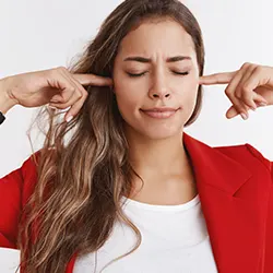 woman shutting her ears with her fingers