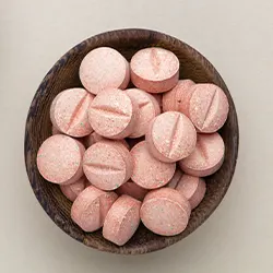 bowl of pink capsules